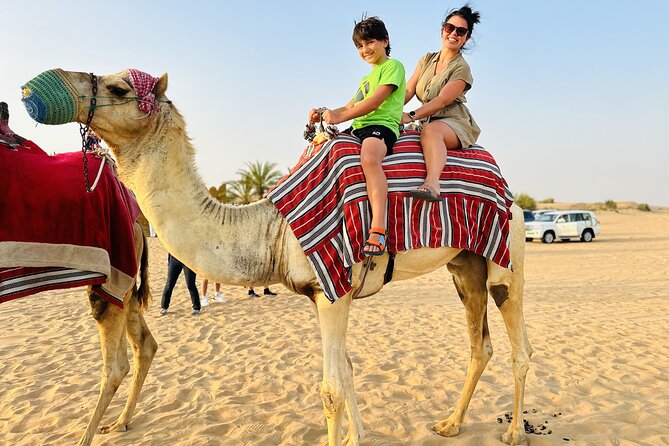 Best Dubai Desert Safari with Buffet Dinner,Sand Boarding & Shows - Sandboarding on soft golden slopes
