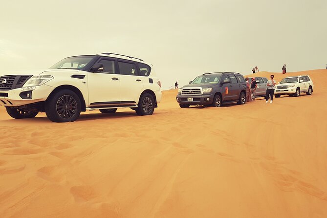 Desert Safari Dubai & Quad Bike with Dinner - Camel riding and sandboarding slow the pace
