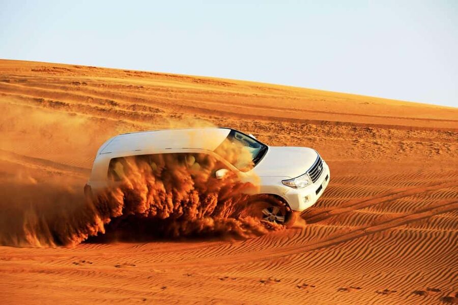 Desert Safari Dubai with Camel Ride, Sandboarding & Dinner - Dune bashing in a 4x4 Land Cruiser