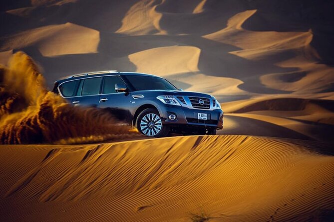 Desert Safari with BBQ Dinner, Camel Ride, Sand Board & Live Show - Dune bashing and the optional quad-bike stop