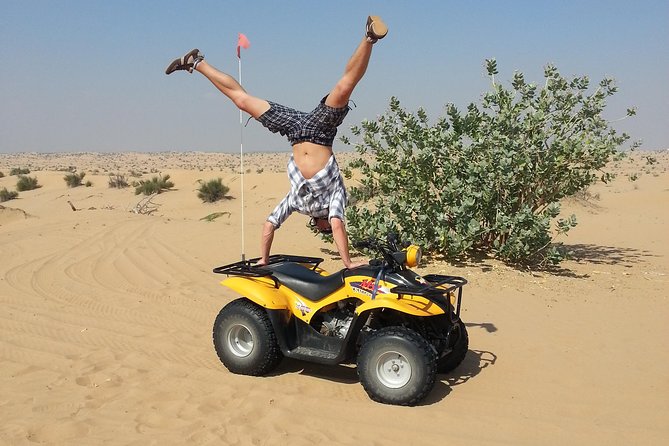 Dubai Desert Morning Tour in 4WD Vehicle: Camel Ride, Quad Bike Tour, Sandboarding, and Camel Farm - Sandboarding down a desert dune