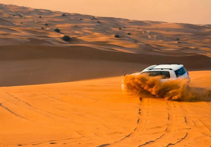 Dubai: Desert Safari, Camel Ride, Sandboard & Buffet Dinner - Dune bashing across the sand
