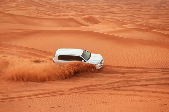 Dubai Desert Safari Dune Bashing, Camel Ride, Sandboarding & BBQ - Lahbab’s red dunes are the main event