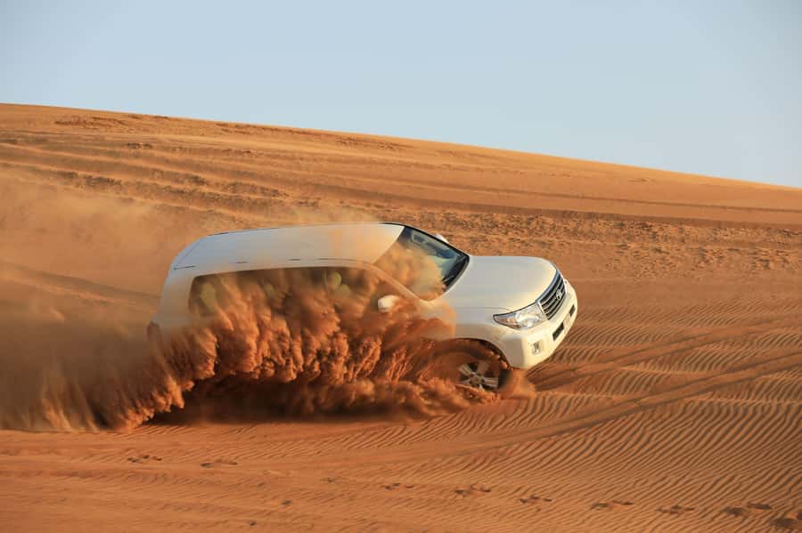 Dubai: Desert Safari, Quad Bike, Sandboarding, Camels & BBQ - Sandboarding adds a simple desert challenge