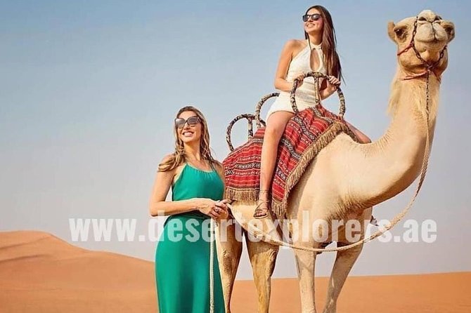 Dubai Desert Safari with Quad Bike, sandboarding, live show & BBQ - Sandboarding with a view across the dunes