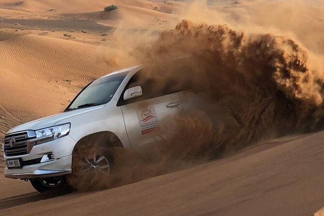 Dubai Evening Desert Safari with BBQ & Live Entertainment - Sandboarding and sunset photos at the highest dunes