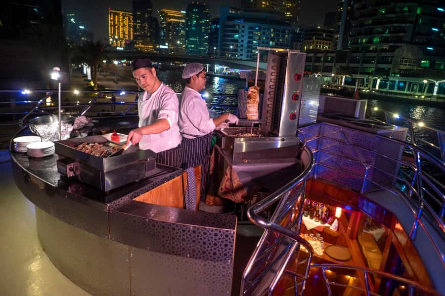 Dubai: Marina Luxury Dhow Dinner Cruise - Boarding a wooden dhow in a modern marina