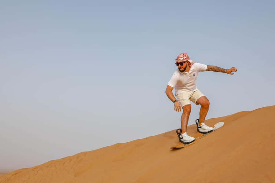 Dubai: Red Dunes Quad Bike with Sandboarding, Camels and BBQ - From Dubai to the red dunes of Lahbab