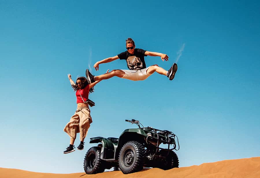 Dubai: Red Dunes Quad Bike with Sandboarding, Camels and BBQ - Sandboarding and desert photo stops