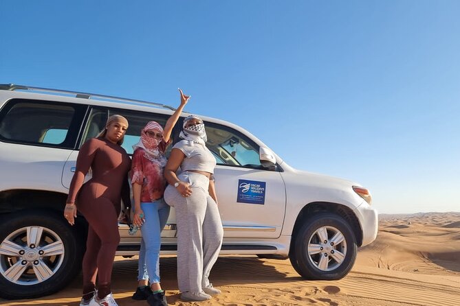 Dubai Red Dunes with Sandboarding, Camel Ride, Falcon & VIP Camp - A short camel ride at twilight
