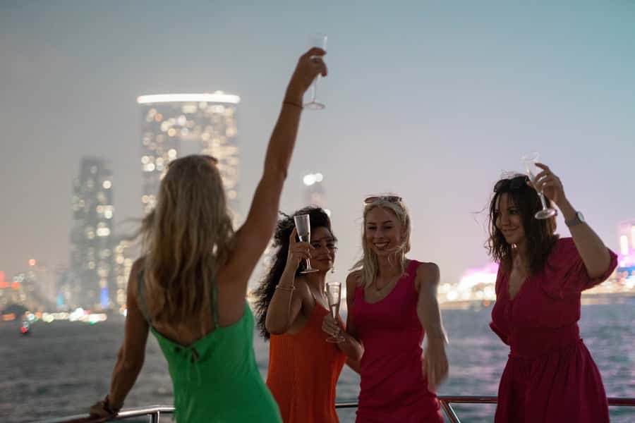 Dubai: Sunset & Night Cruise with Bites and Drinks - How the crew shapes the evening