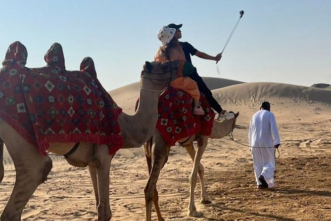 Evening Desert Safari Abu Dhabi with Hot BBQ Dinner - Sandboarding, skiing, henna, and costume photos