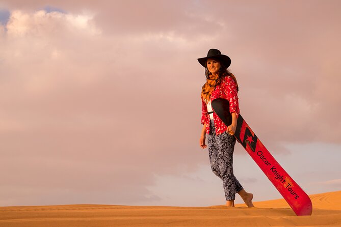 High Red Dunes with Camel Ride, Sandboarding, Falcon Show and VIP BBQ Dinner - Sandboarding on soft red sand