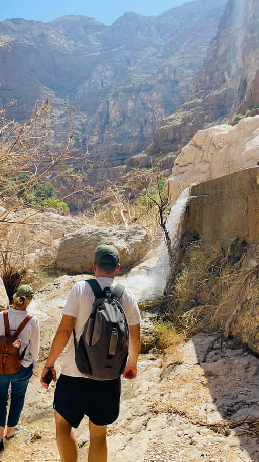 Muscat: Wadi Shab, Romantic Cave and Sinkhole Full-day Trip - Swimming toward the waterfall cave