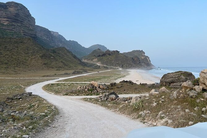 West Salalah Tour - Caribbean of Orient - Fazayah Beach with City - The long descent to Fazayah Beach